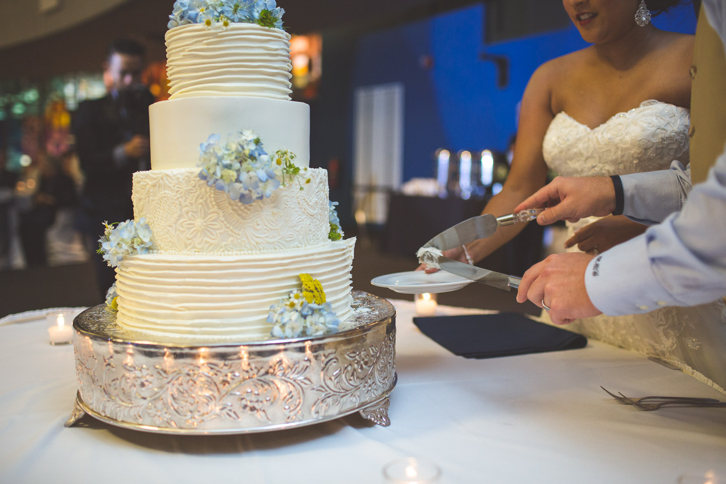 silver-garden-events-center-michigan-southfield-bride-groom-cut-cake-slice